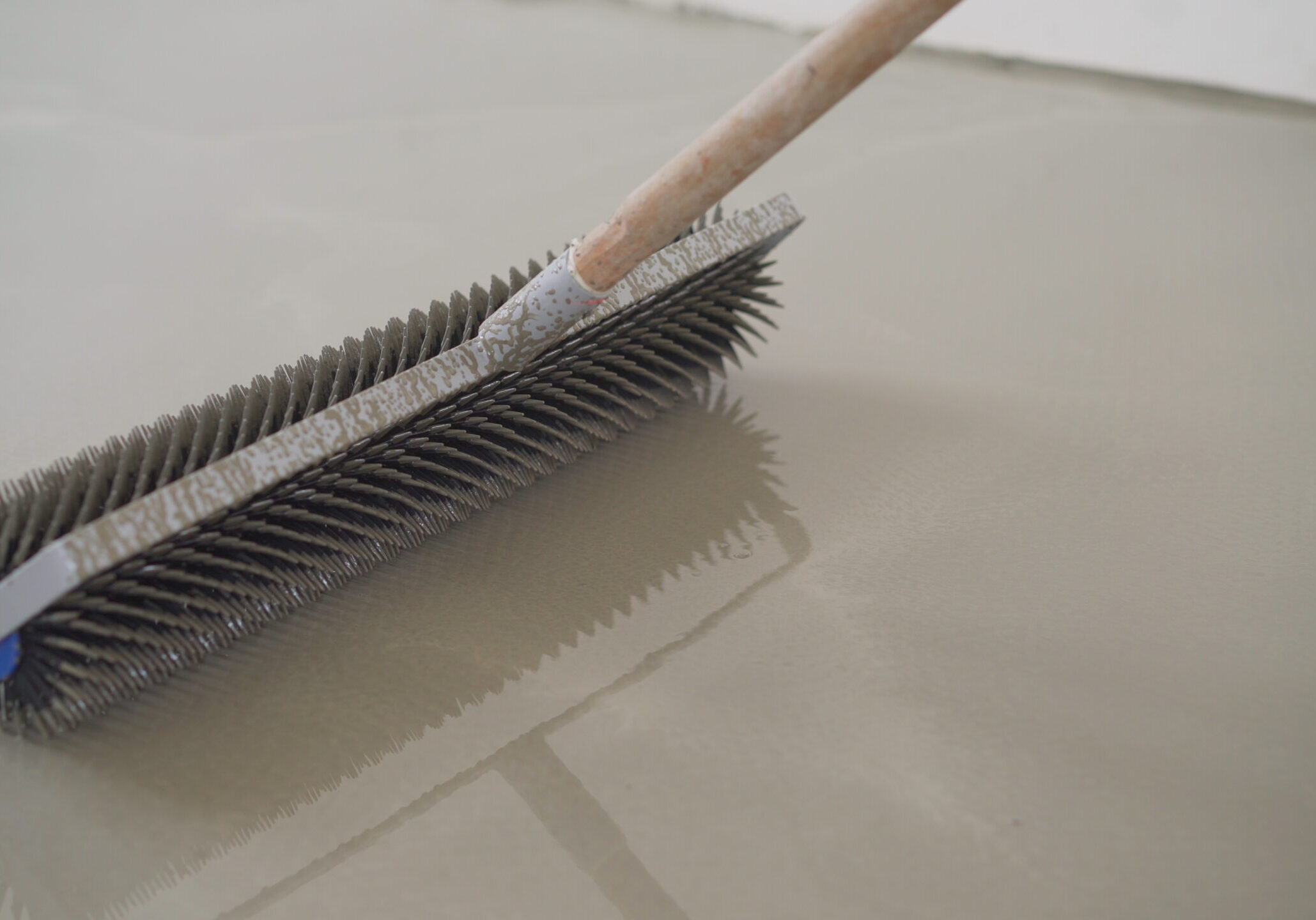 Charcoal roller. Self-leveling floor tool. Self-leveling epoxy. Leveling with a mixture of cement floors. Charcoal roller on the self-leveling floor.